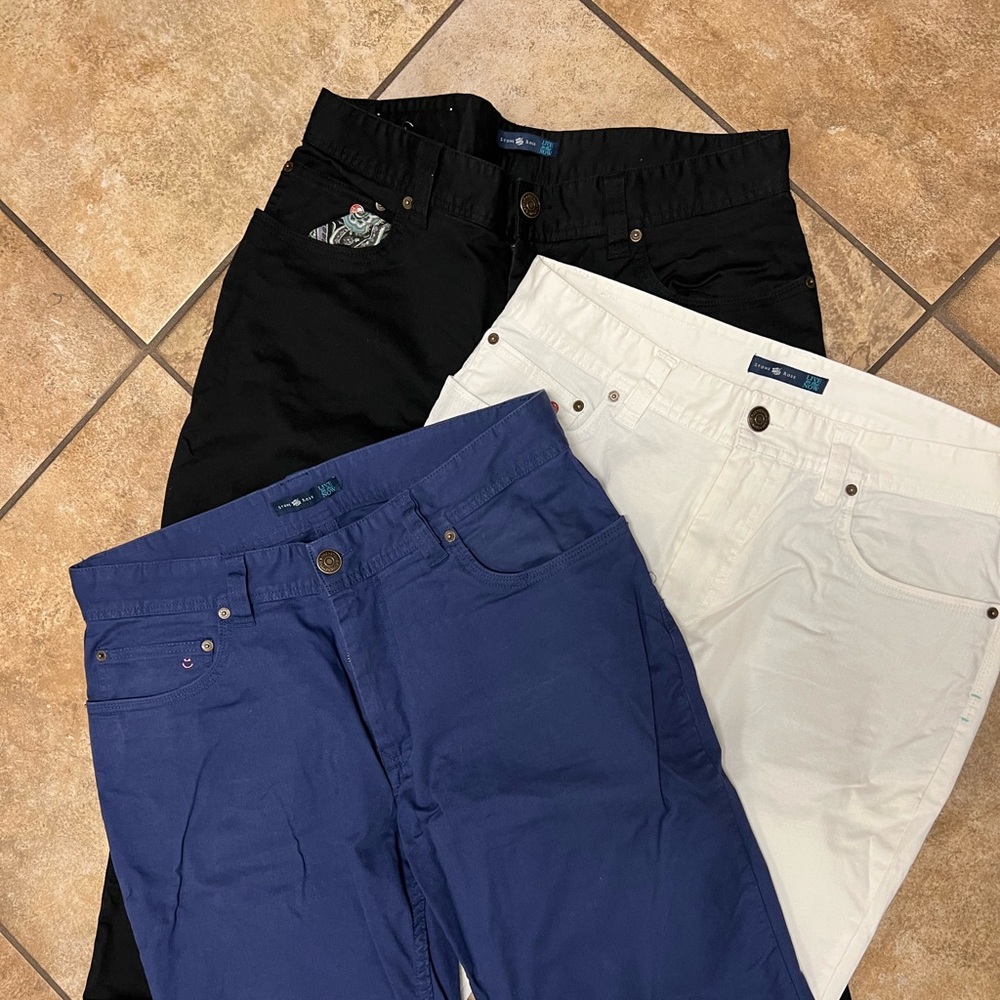 Three pairs of Stone Rose pants, size 34 in blue and 33 and white and 33 black